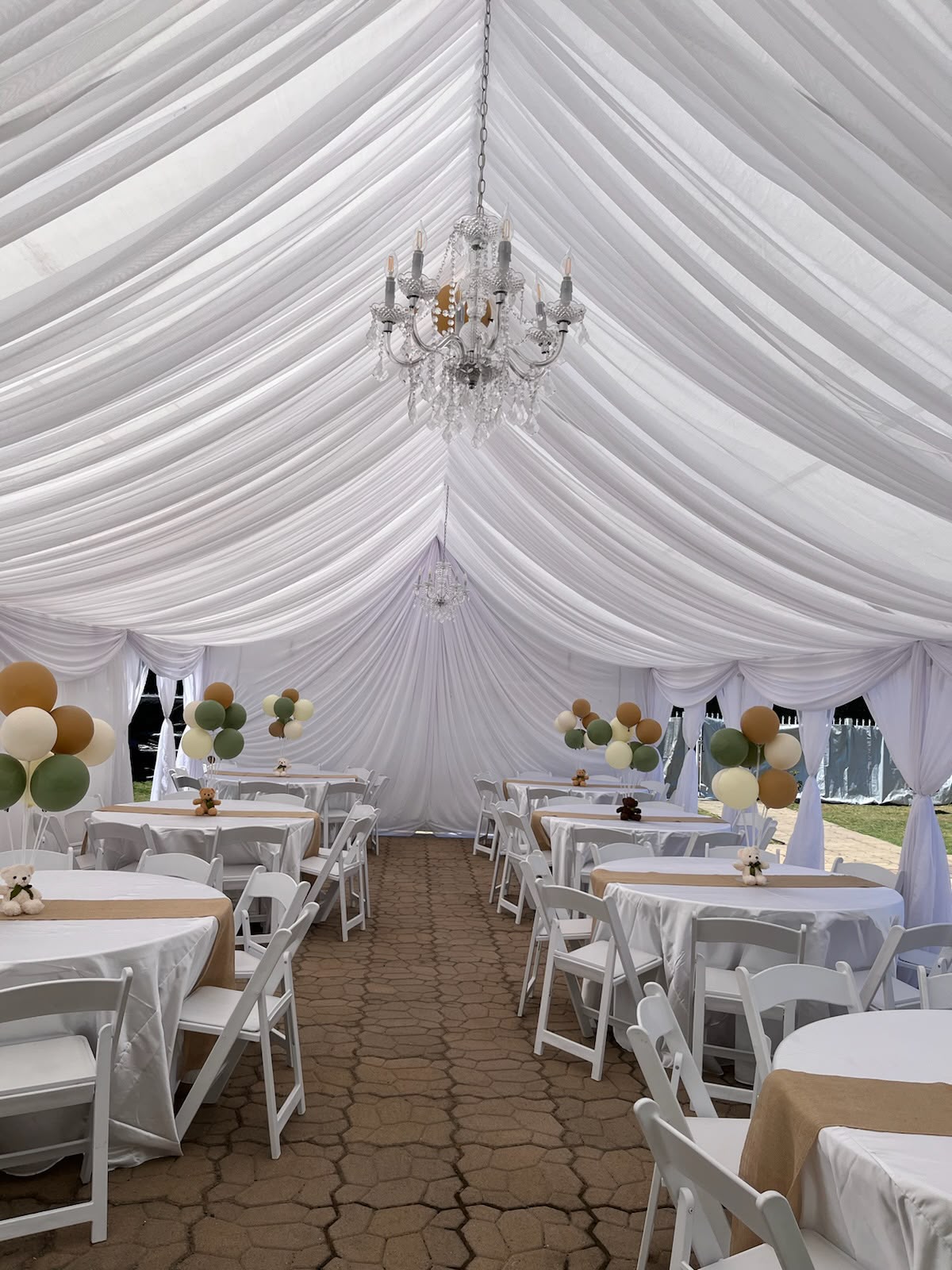 All-white custom tent draping with chandeliers